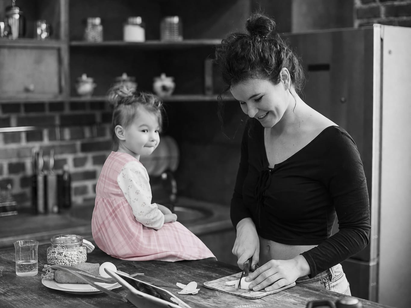 Mother and daughter cooking together in a warm kitchen